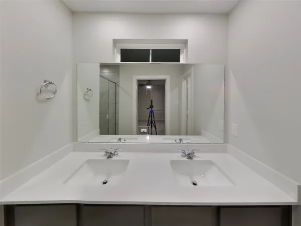 a bathroom with a shower and a sink