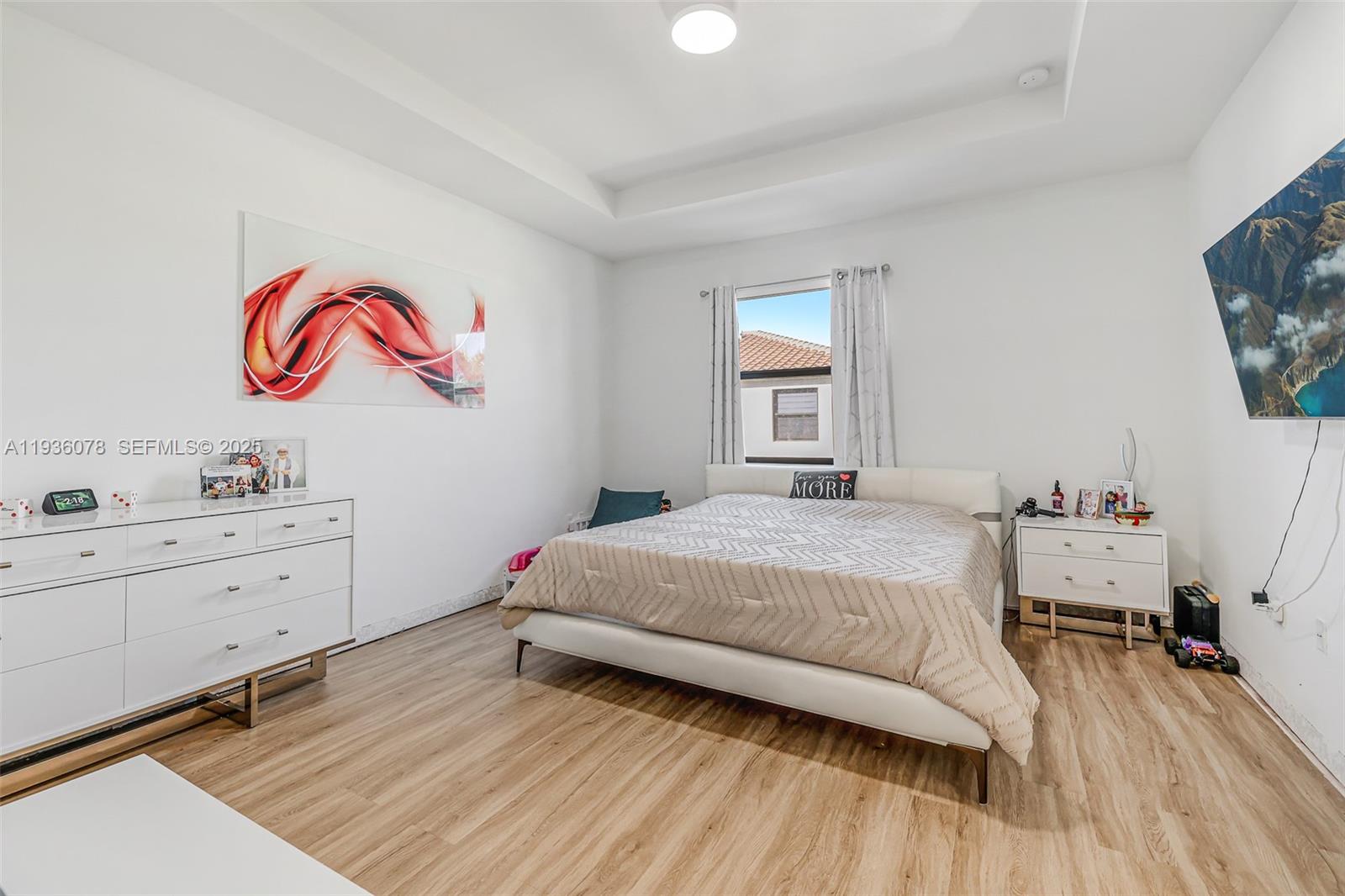 11907 Southwest 247th Terrace Homestead, FL 33032 - Photo 15 of 35 a bedroom with a bed and a flat screen tv