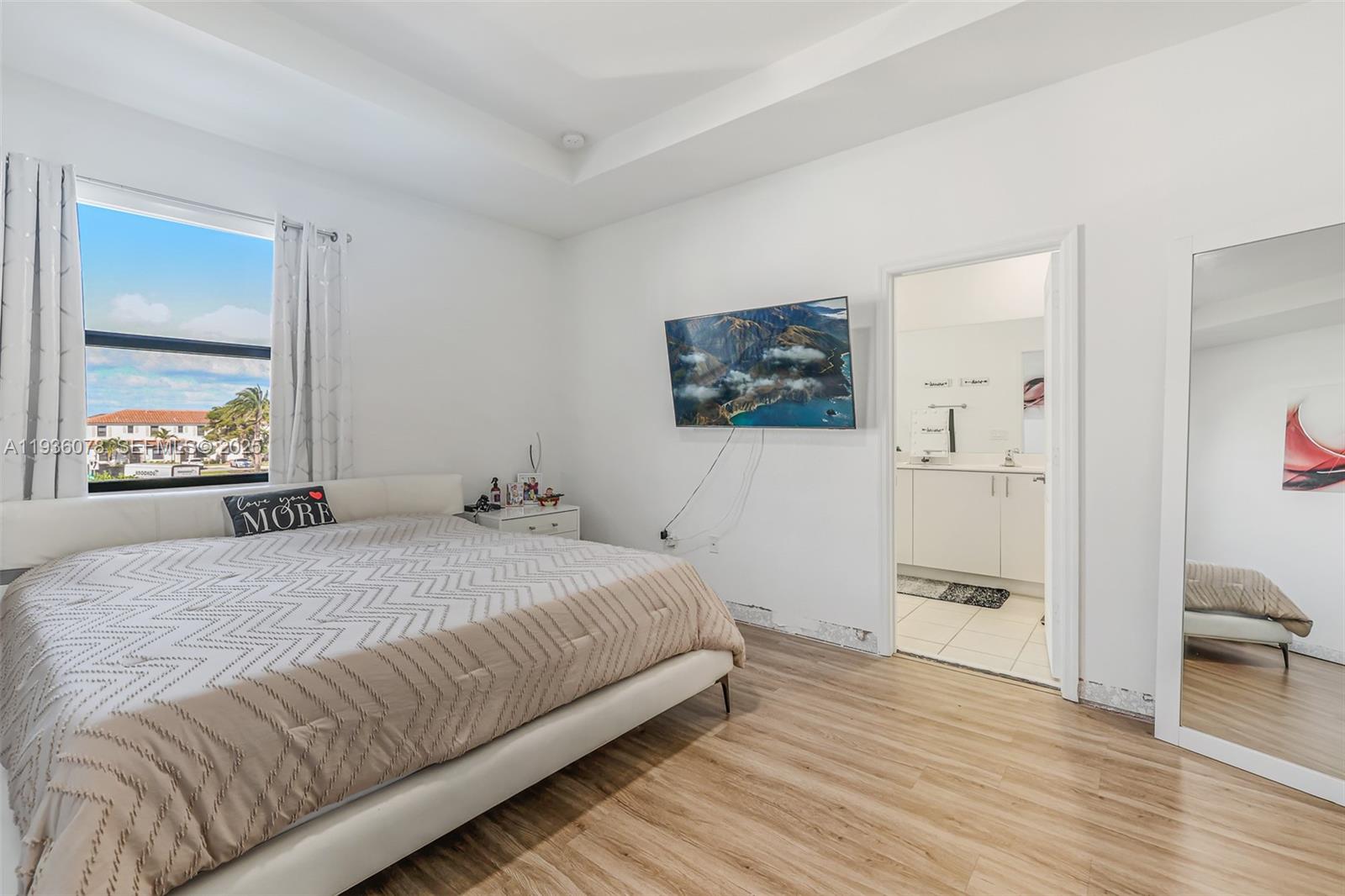 11907 Southwest 247th Terrace Homestead, FL 33032 - Photo 16 of 35 a bedroom with a bed and a painting on the wall