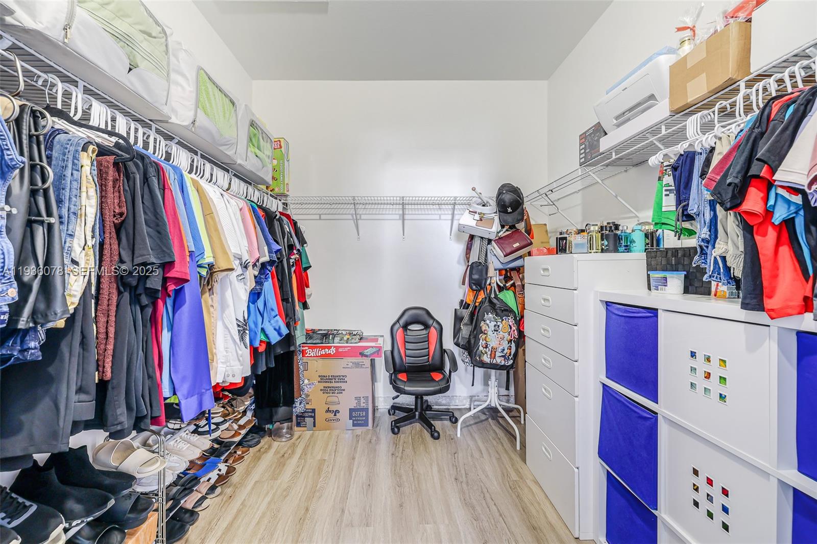 11907 Southwest 247th Terrace Homestead, FL 33032 - Photo 19 of 35 a view of walk in closet with clothes and shoes