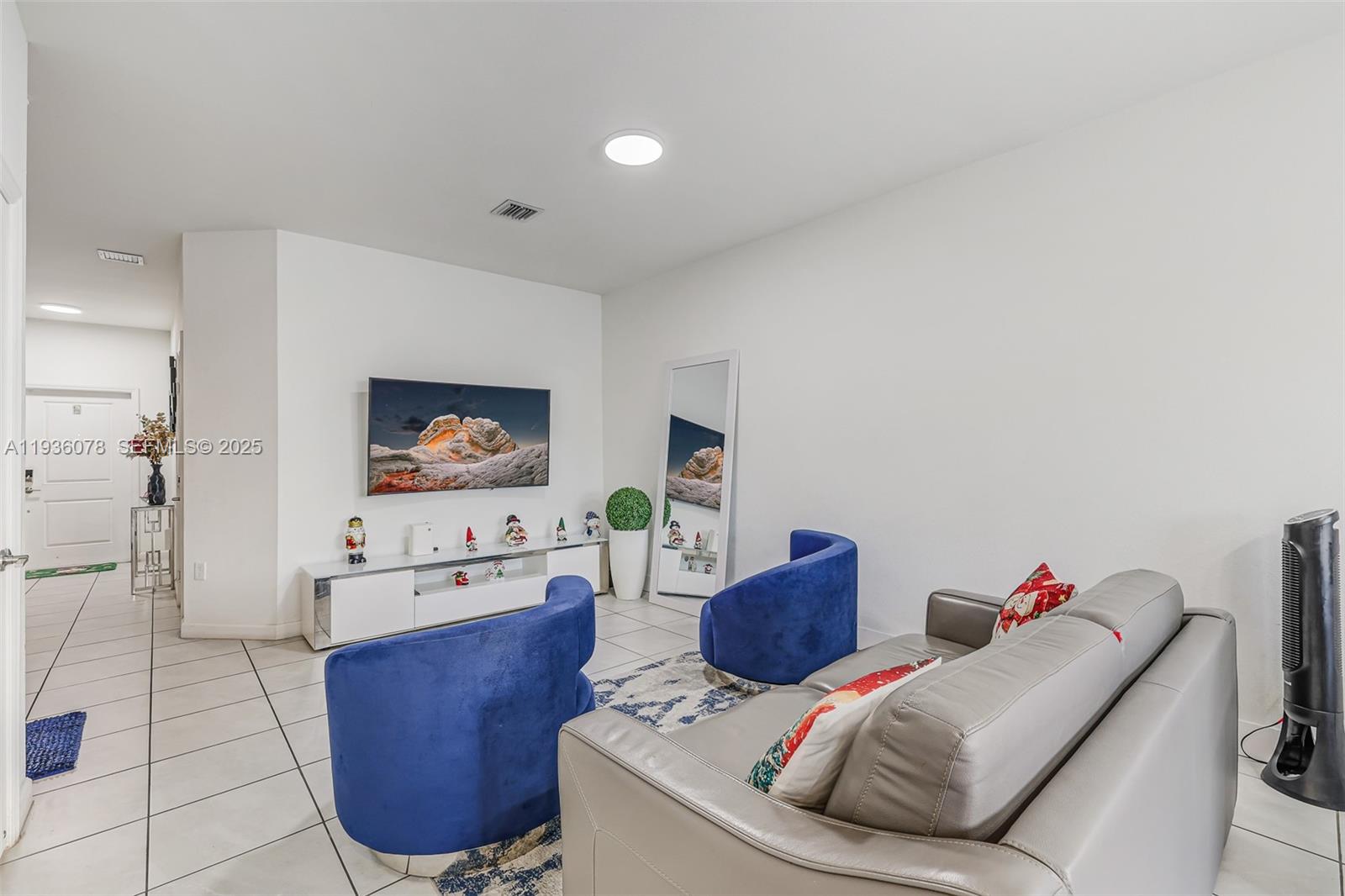 11907 Southwest 247th Terrace Homestead, FL 33032 - Photo 5 of 35 a living room with furniture and a flat screen tv