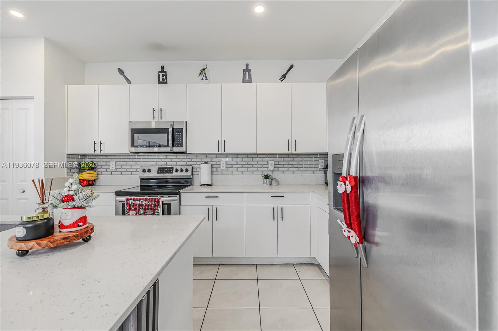 11907 Southwest 247th Terrace Homestead, FL 33032 - Photo 9 of 35 a kitchen with stainless steel appliances and cabinets