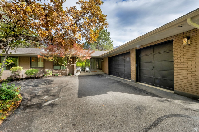 6299 South Van Cott Road Holladay, UT 84121 - Photo 1 of 1 Single story home featuring brick siding, asphalt driveway, and an attached garage