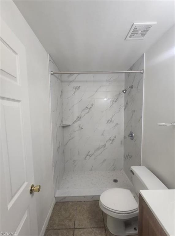1854 55th Terrace Southwest Naples, FL 34116 - Photo 7 of 9 Bathroom with vanity, a marble finish shower, and light tile patterned floors