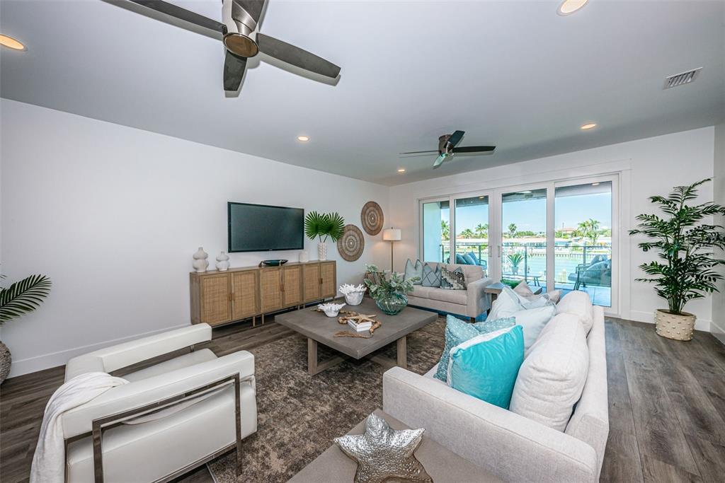 12305 3rd Street East, Unit 2 Treasure Island, FL 33706 - Photo 20 of 69 a living room with furniture and a flat screen tv