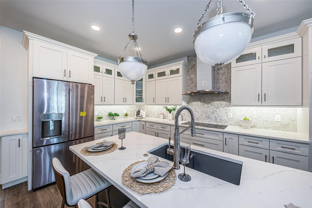 12305 3rd Street East, Unit 2 Treasure Island, FL 33706 - Photo 25 of 69 a kitchen with stainless steel appliances granite countertop a sink refrigerator and cabinets