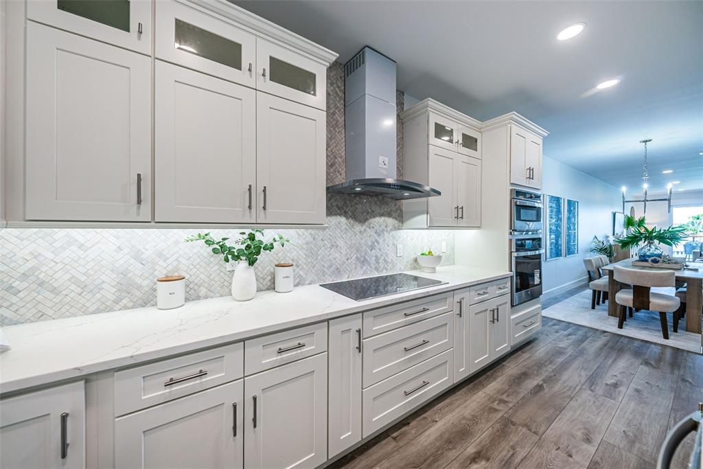 12305 3rd Street East, Unit 2 Treasure Island, FL 33706 - Photo 27 of 69 a kitchen with granite countertop white cabinets and white appliances