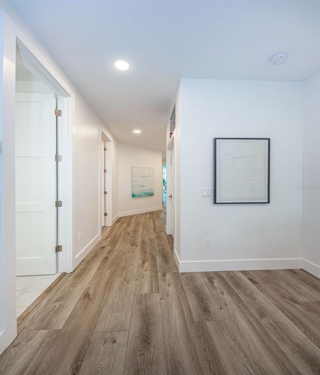 12305 3rd Street East, Unit 2 Treasure Island, FL 33706 - Photo 33 of 69 a view of a hallway with wooden floor