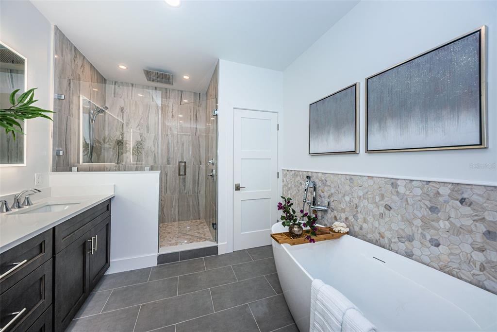 12305 3rd Street East, Unit 2 Treasure Island, FL 33706 - Photo 42 of 69 a bathroom with a tub sink and mirror