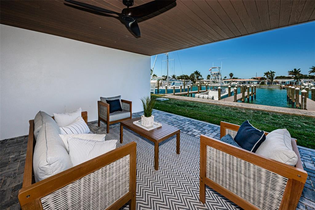 12305 3rd Street East, Unit 2 Treasure Island, FL 33706 - Photo 48 of 63 a view of a roof deck with table and chairs barbeque oven with a table and chairs