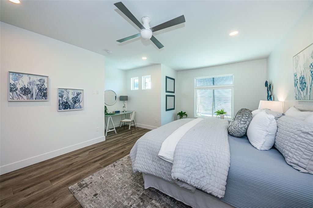 12305 3rd Street East, Unit 2 Treasure Island, FL 33706 - Photo 49 of 69 a bedroom with a large bed couch and a window