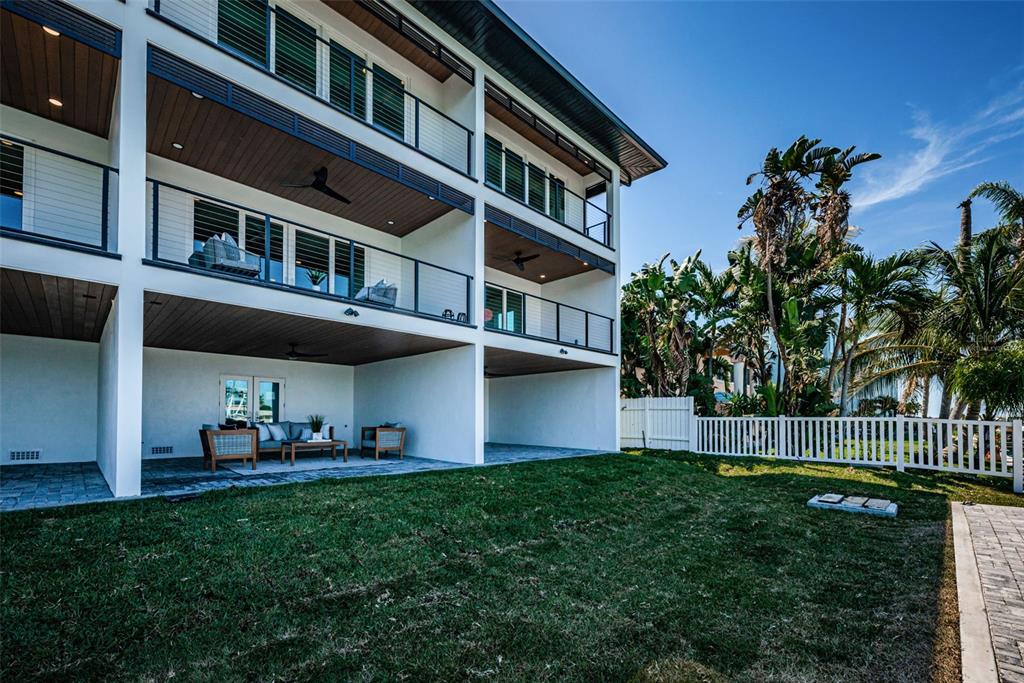 12305 3rd Street East, Unit 2 Treasure Island, FL 33706 - Photo 54 of 63 a front view of a building with a garden and plants