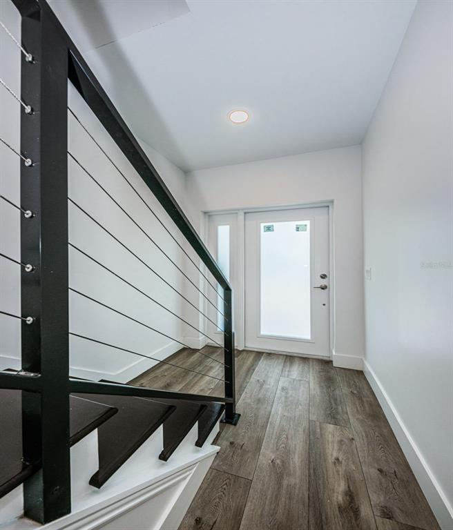 12305 3rd Street East, Unit 2 Treasure Island, FL 33706 - Photo 8 of 69 a view of a hallway with wooden floor and staircase