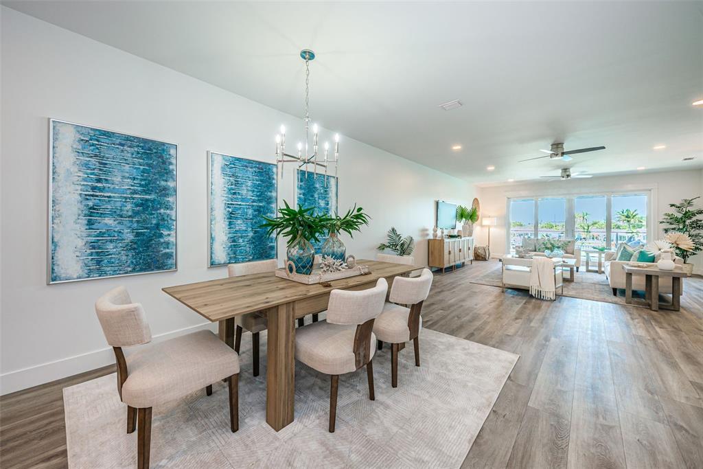 12305 3rd Street East, Unit 2 Treasure Island, FL 33706 - Photo 10 of 69 a view of a dining room and livingroom with furniture wooden floor a chandelier