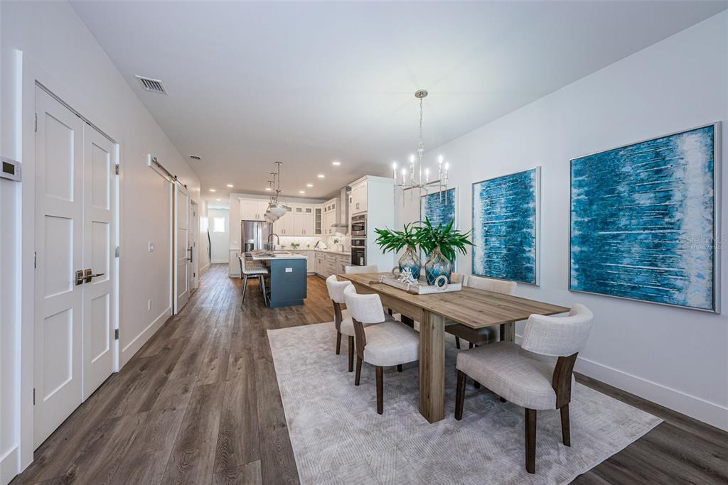 12305 3rd Street East, Unit 2 Treasure Island, FL 33706 - Photo 10 of 63 a view of a dining room with furniture window and wooden floor