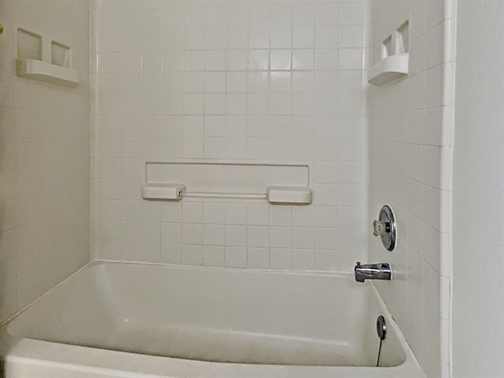 6830 Shallow River Court Spring, TX 77379 - Photo 11 of 17 a bathroom with a bathtub