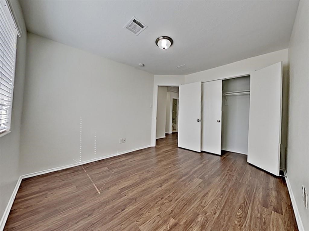 6830 Shallow River Court Spring, TX 77379 - Photo 12 of 17 a view of an empty room with wooden floor