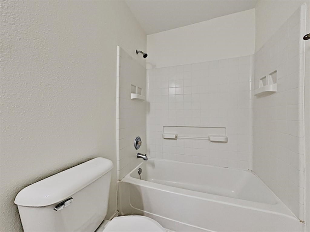 6830 Shallow River Court Spring, TX 77379 - Photo 14 of 17 a bathroom with a toilet and a bathtub