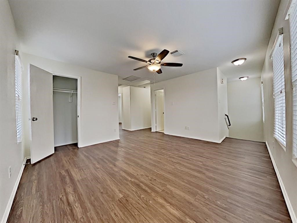 6830 Shallow River Court Spring, TX 77379 - Photo 15 of 17 an empty room with wooden floor and a ceiling fan