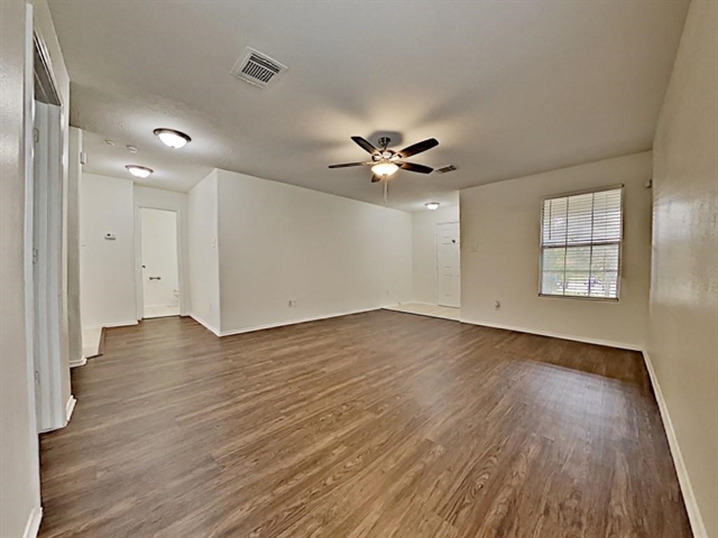 6830 Shallow River Court Spring, TX 77379 - Photo 6 of 17 an empty room with wooden floor and windows