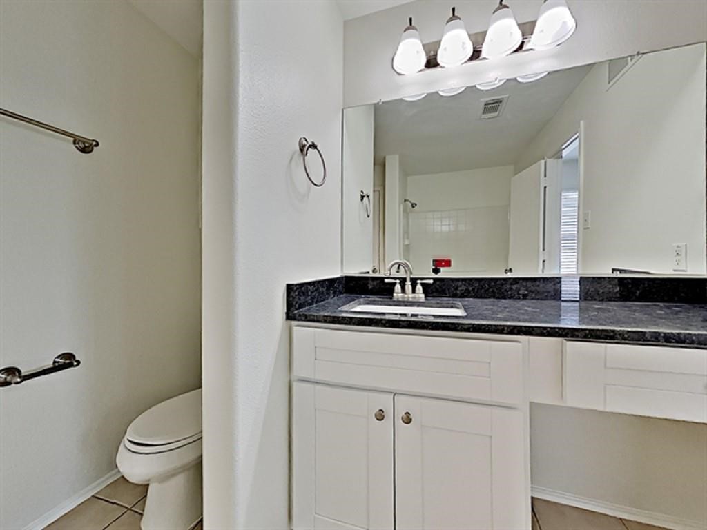 6830 Shallow River Court Spring, TX 77379 - Photo 10 of 17 a bathroom with a sink a toilet and a mirror