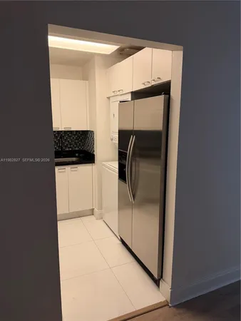 a bathroom with a glass shower door and a sink