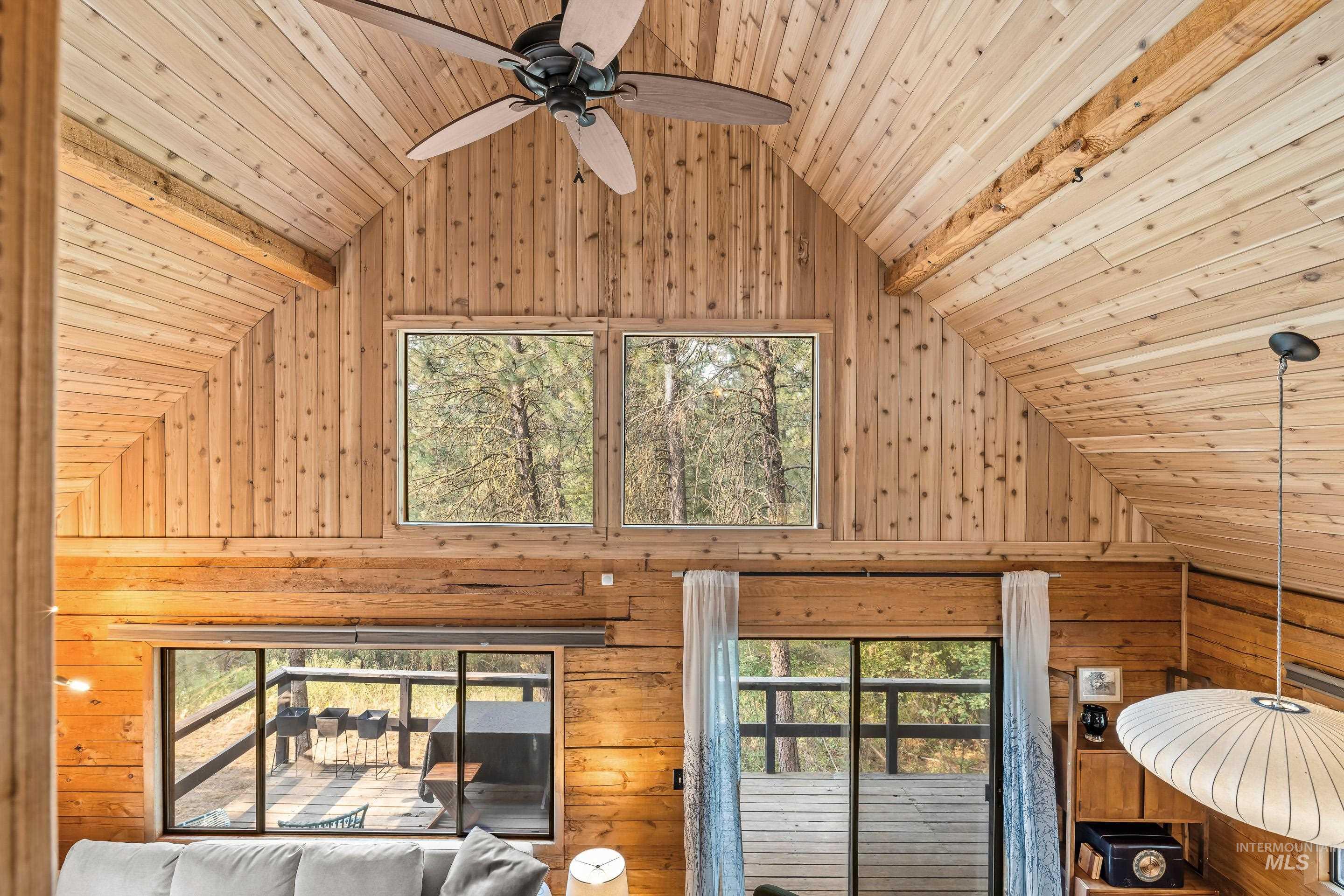 73 Rainbow Ridge Road Garden Valley, ID 83622 - Photo 35 of 49 Vaulted wood-paneled ceiling, exposed wood beams, and a ceiling fan