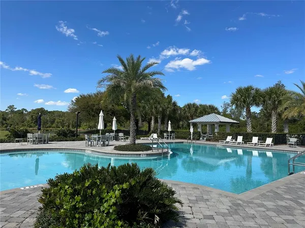 a view of a swimming pool with outdoor seating