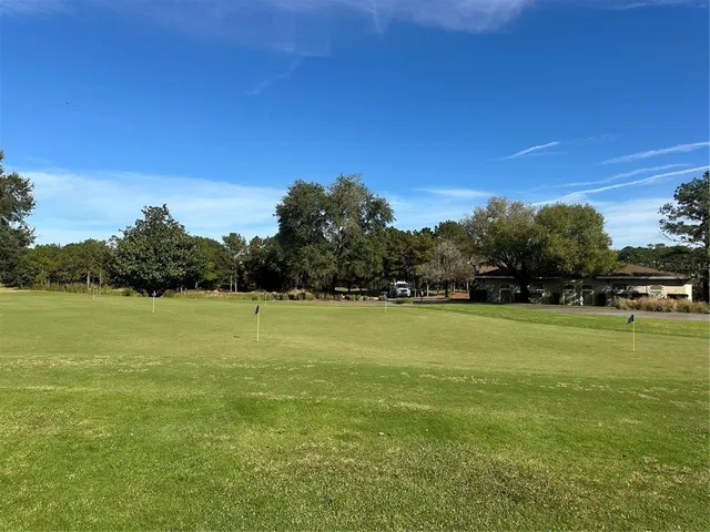 a view of a golf course with green space