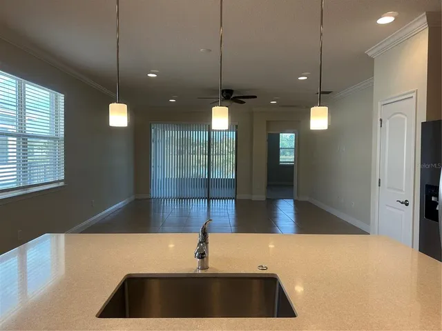 a kitchen with a sink cabinetry and a chandelier