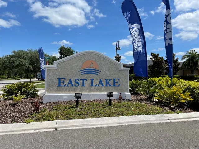 a front view of a house with a yard and potted plants