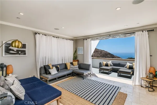a living room with furniture a rug and a large window