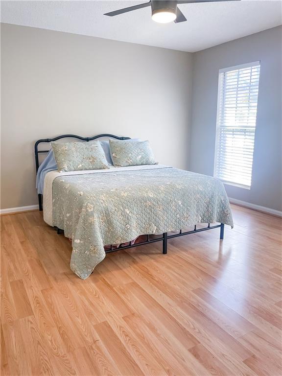 280 Mimosa Road Phenix City, AL 36870 - Photo 21 of 38 Bedroom with light wood-type flooring, ceiling fan, and a textured ceiling