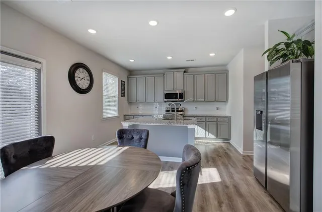 a kitchen with stainless steel appliances granite countertop a refrigerator sink and stove