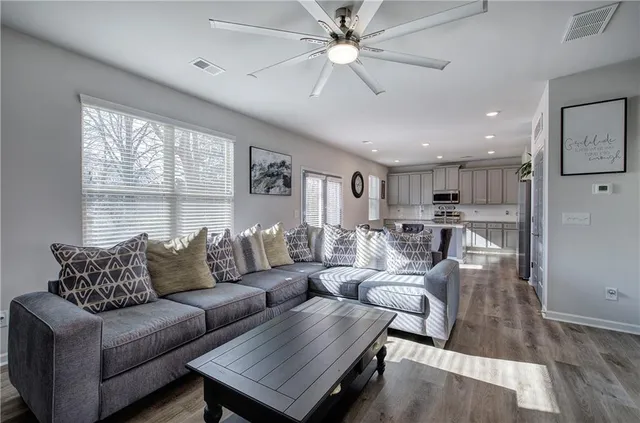 a living room with furniture and a large window