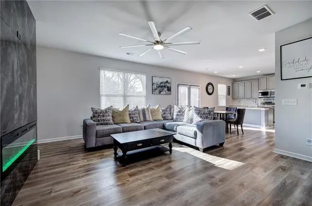 a living room with furniture and wooden floor
