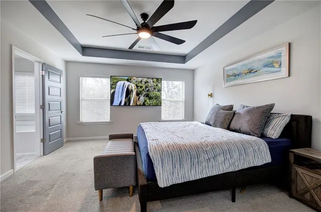 a bedroom with a bed and a ceiling fan