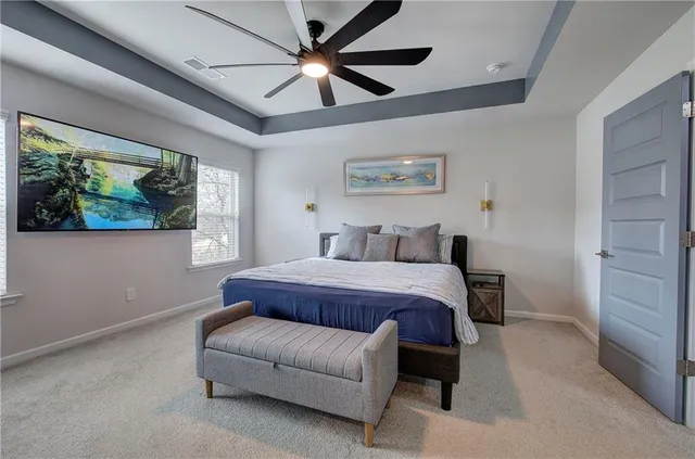 a bedroom with a bed and a dresser next to a window