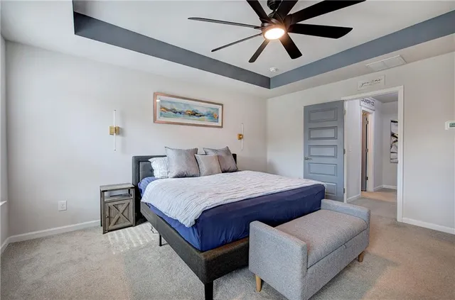 a spacious bathroom with a granite countertop sink a mirror a bathtub and shower