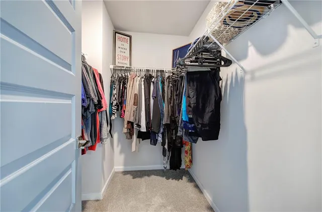 a view of a livingroom with a ceiling fan and window