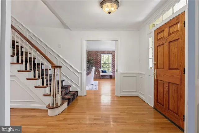 a dining room with furniture window and wooden floor