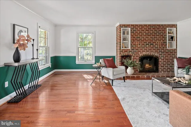 a kitchen with stainless steel appliances wooden floors and white cabinets