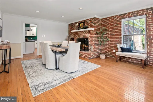 a living room with furniture a rug a window and a lamp