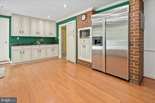 a bathroom with a sink a toilet a window and shower