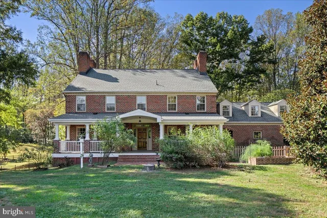 a front view of a house with a garden and plants