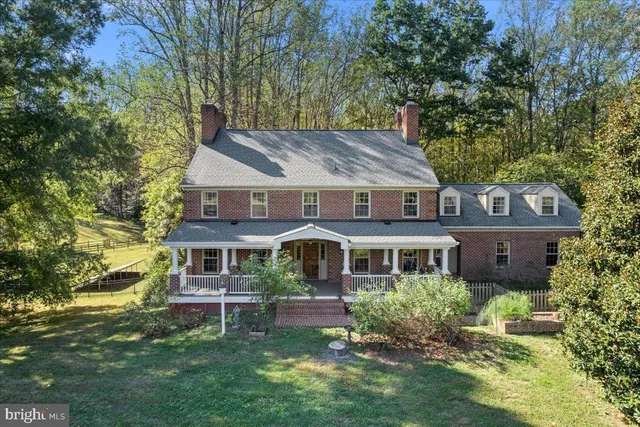 a view of an entryway with wooden floor and staircase
