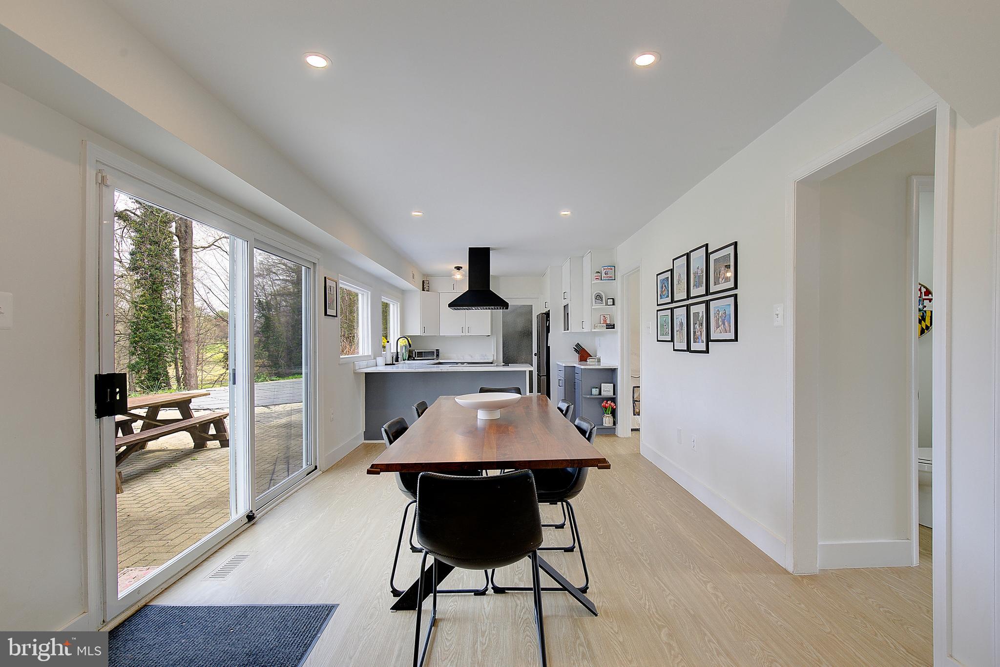 1702 Saxony Place Crofton, MD 21114 - Photo 21 of 65 a dining room with furniture and wooden floor