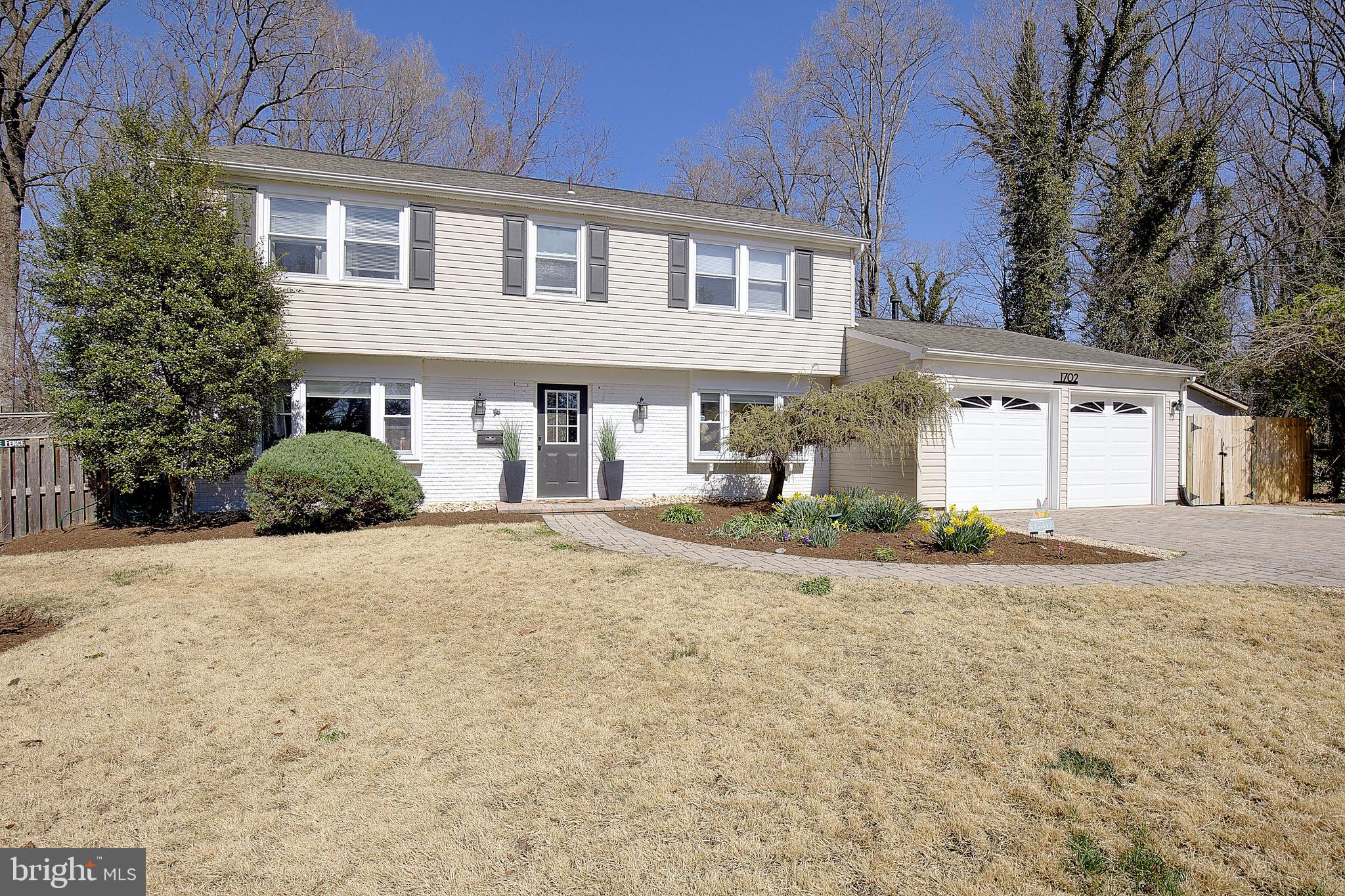 1702 Saxony Place Crofton, MD 21114 - Photo 4 of 65 a front view of a house with a yard and garage