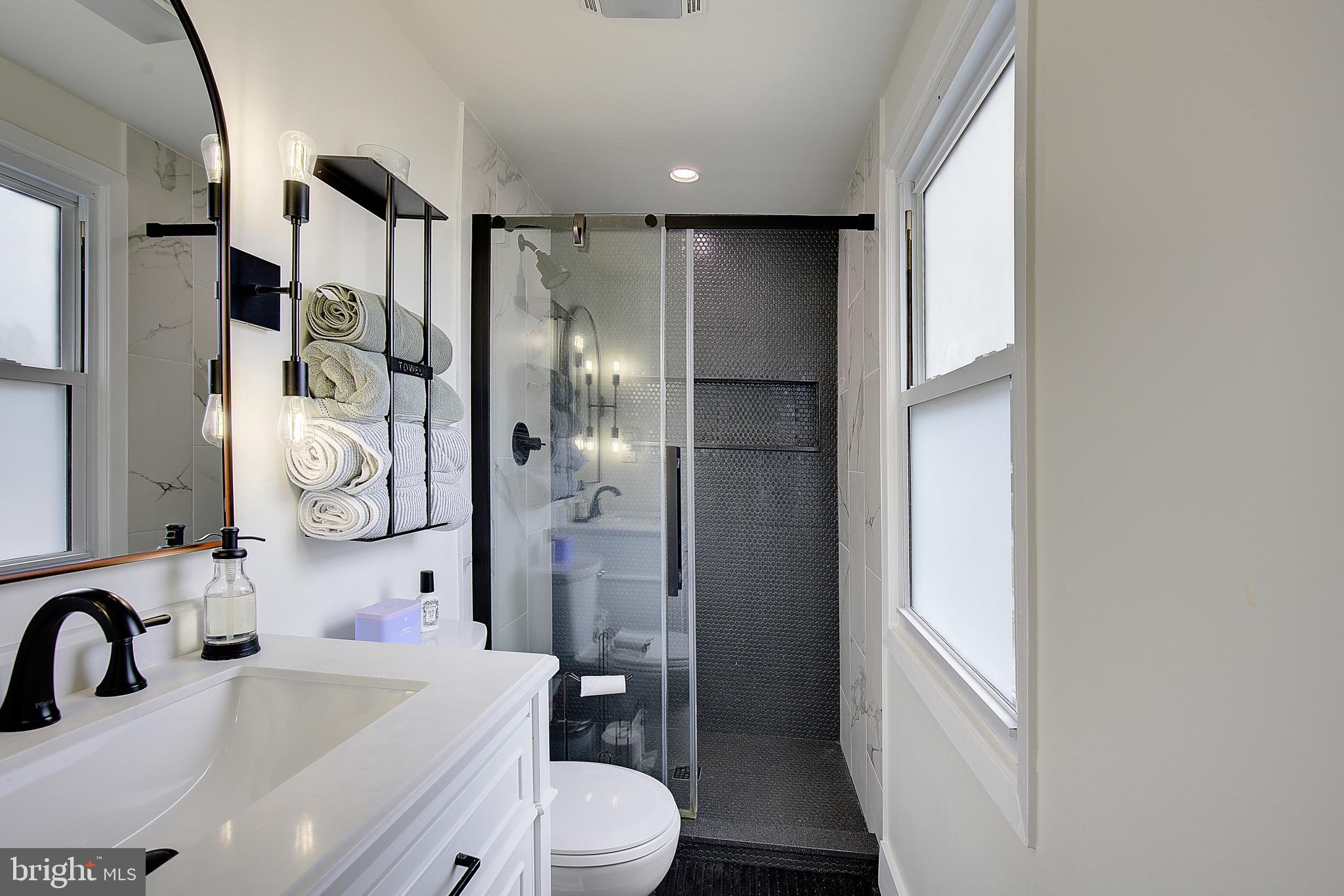 1702 Saxony Place Crofton, MD 21114 - Photo 41 of 65 a bathroom with a bathtub shower sink mirror and toilet