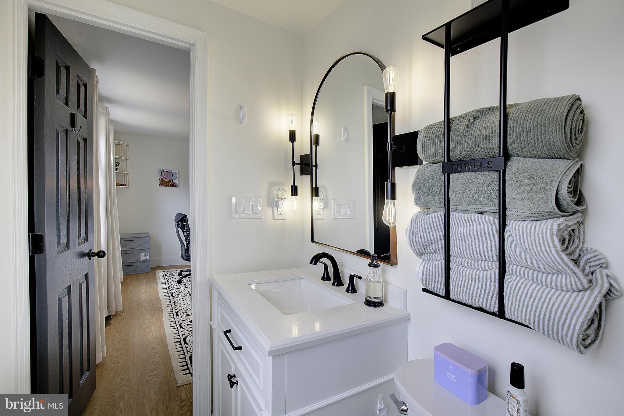 1702 Saxony Place Crofton, MD 21114 - Photo 42 of 65 a en suite bathroom with a sink and mirror